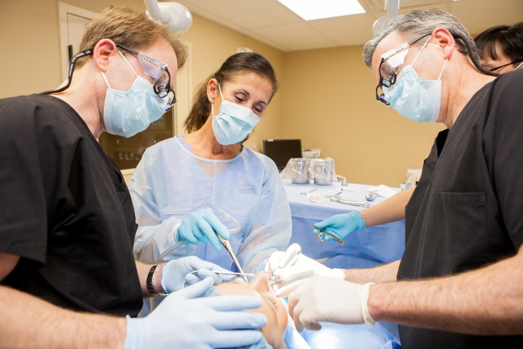 Oral Surgeon and staff with a patient